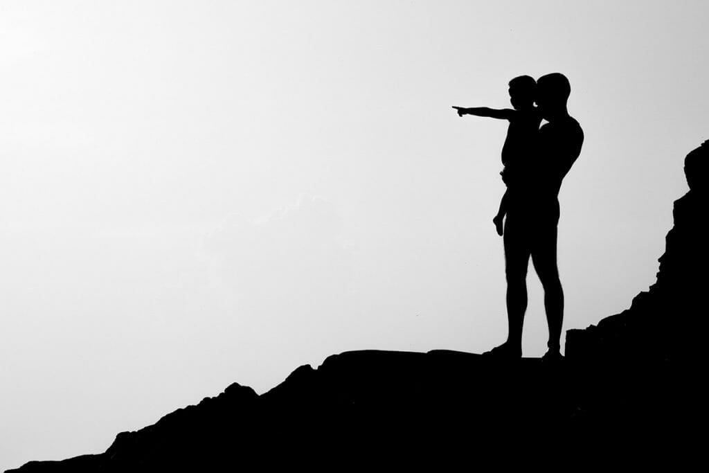 Father and Son on hill silhouette
