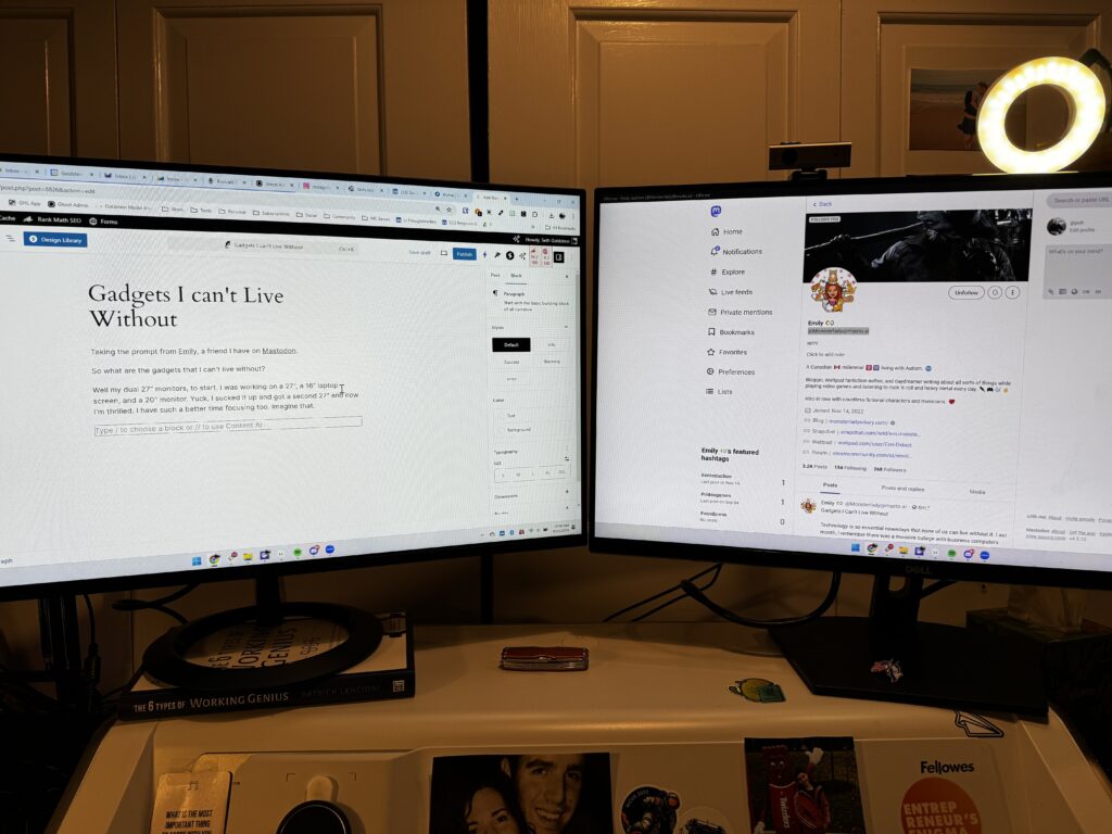 two computer monitors on a standing desk