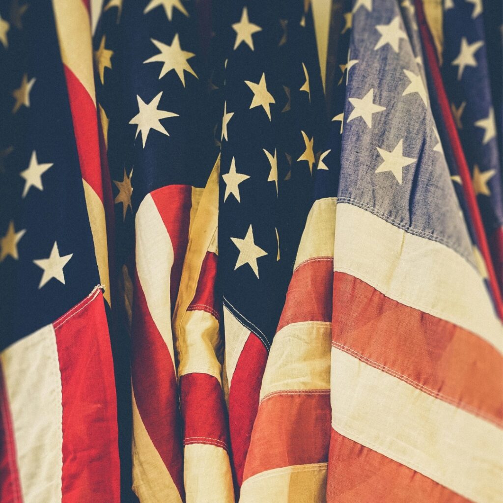 Grouping of American flags with sepia tone filter over it.